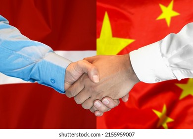 Business Handshake On Background Of Two Flags. Men Handshake On Background Of China And Latvia Flag. Support Concept