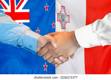 Business handshake on background of two flags. Men handshake on background of New Zealand flag and flag of Malta. Support concept - Shutterstock ID 2236171377