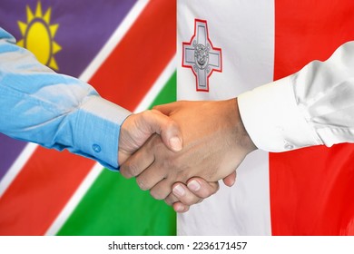 Business handshake on background of two flags. Men handshake on background of Namibia flag and flag of Malta. Support concept - Shutterstock ID 2236171457