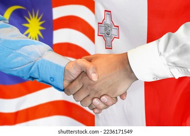 Business handshake on background of two flags. Men handshake on background of Malaysia flag and flag of Malta. Support concept - Shutterstock ID 2236171549