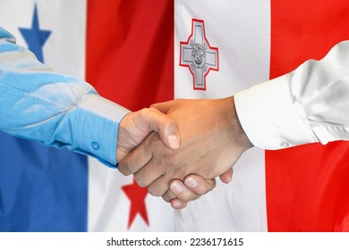 Business handshake on background of two flags. Men handshake on background of Panama flag and flag of Malta. Support concept - Shutterstock ID 2236171615