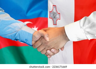 Business handshake on background of two flags. Men handshake on background of Azerbaijan flag and flag of Malta. Support concept - Shutterstock ID 2236171669
