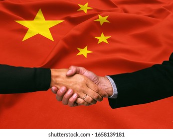 Business Handshake On China  Flag Background 