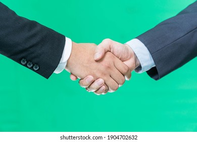 Business handshake on green screen background, partnership trust, respect sign - Powered by Shutterstock