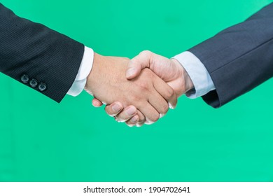 Business handshake on green screen background, partnership trust, respect sign - Powered by Shutterstock