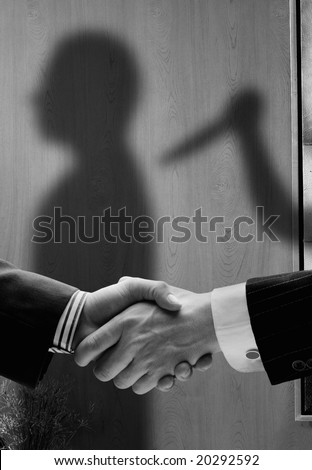 business handshake with shadows behind showing  real intentions showing a man being stabbed in the back