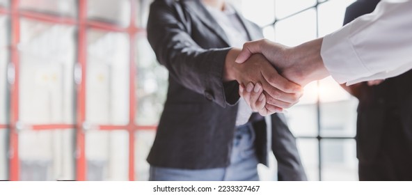 Business handshake for teamwork of business merger and acquisition,successful negotiate,hand shake,two businessman shake hand with partner to celebration partnership and business deal concept - Shutterstock ID 2233327467