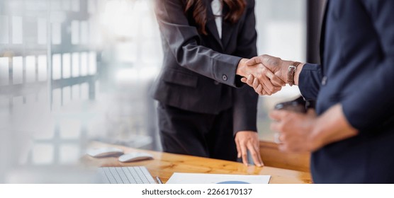 Business handshake for teamwork of business merger and acquisition,successful negotiate,hand shake,two businessman shake hand with partner to celebration partnership and business deal concept	 - Powered by Shutterstock