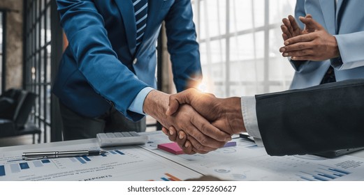 Business handshake for teamwork of business merger and acquisition,successful negotiate,hand shake,two businessman shake hand with partner to celebration partnership and business deal concept. - Powered by Shutterstock