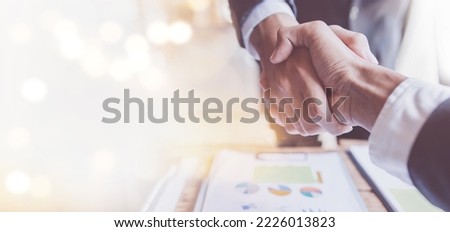 Business handshake for teamwork of business merger and acquisition,successful negotiate,hand shake,Asian businessman shake hand with partner to celebration partnership and business deal concept