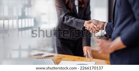 Business handshake for teamwork of business merger and acquisition,successful negotiate,hand shake,two businessman shake hand with partner to celebration partnership and business deal concept	