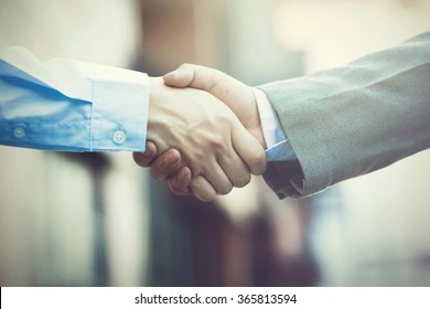 Business handshake. Two businessman shaking hands (Vintage tone)