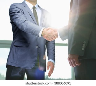 Business handshake. Two businessman shaking hands in the office. - Powered by Shutterstock