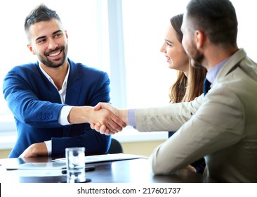 Business handshake. Handshake of two business men closing a deal at the office