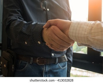 
Business handshake of two men demonstrating their agreement to sign agreement or contract between their firms / companies / enterprises.