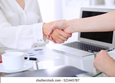 Business handshake. Two women are shaking hands after meeting or  negotiation. 