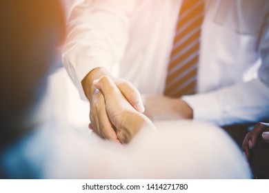 business handshaking process after successful deal of business meeting,Close up image handshake of business partnership - Shutterstock ID 1414271780