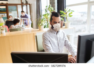 Business, Health And People Concept - Businessman Or Creative Male Office Worker Wearing Face Protective Medical Mask For Protection From Virus Disease With Computer