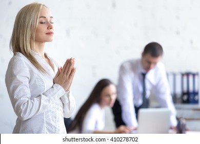 Business And Healthy Lifestyle Concept. Beautiful Young Office Woman Meditating And Relaxing With Closed Eyes At Workplace. Attractive Business Lady Using Stress Relief Techniques At Work. Copy Space