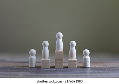 Business Hierarchy, Ranking And Strategy Concept With Wood Doll Standing On A Podium 1, 2, 3 Of Wooden Building Blocks With Copy Space.