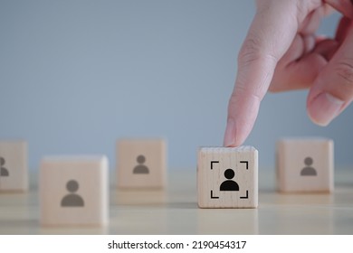 Business Hiring And Recruitment Selection. Career Opportunity. Human Resource Management. Hand Touching Focus Human Icon On Wooden Block. Choice Of Employee Leader From The Crowd.