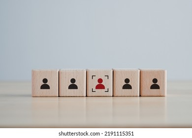 Business hiring and recruitment selection. Career opportunity. Human Resource Management. Focus red human icon on wooden block. Choice of employee leader from the crowd.