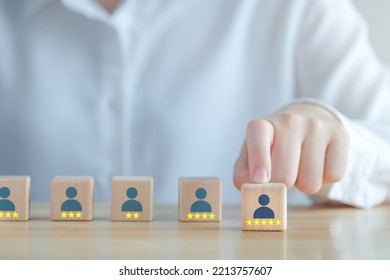 Business Hiring And Recruitment Selection. Career Opportunity. Human Resource Management. Hand Select Human Icon With 5 Star On Wooden Block. Choice Of Employee Leader From Many People.