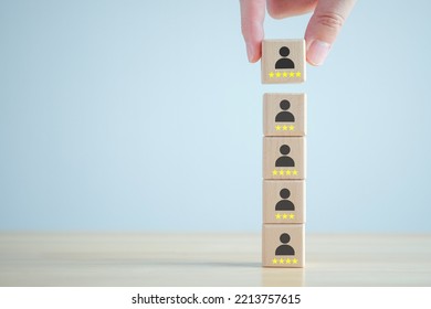 Business Hiring And Recruitment Selection. Career Opportunity. Human Resource Management. Hand Choosing Human Icon On Wooden Block With 5 Star. Choice Of Employee Leader From Many People.