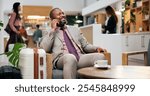 Business, hotel and man in lounge with phone call, smile and luggage in lobby for communication. Travel, booking and happy businessman at reception on smartphone with hospitality, suitcase and relax