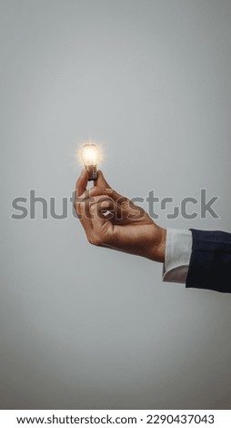 Business idea concept, Hands of business woman in suit holding light bulb with innovation and inspiration creative agency new beginning Analyzing data
