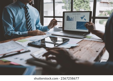 Business idea. Business people talking And calculations about charts and graphs showing the growth of investment results Of successful teamwork - Shutterstock ID 2367258677
