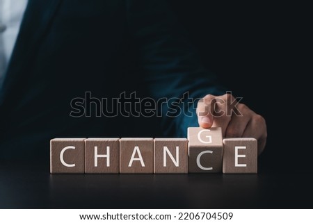 Business ideas and professional growth, businessman's hands turn wooden cubes from CHANGE to CHANCE, strategic thinking and ways to turn crisis into competitive opportunity for business.