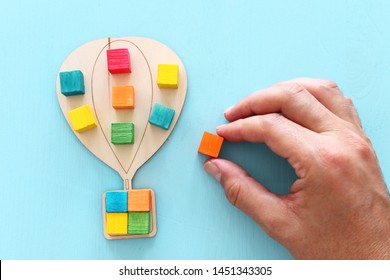 Business image of wooden air balloon with colorful cubes over blue table, human resources and management concept - Shutterstock ID 1451343305
