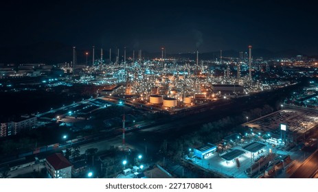 business and industrial area production plant or refinery crude oil and gas for transportatioon and export, aerial photography at night scene from drone, - Powered by Shutterstock