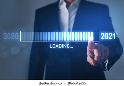 Business innovation and inspiration for new year 2021. Loading new year 2020 to 2021 with businessman hand pointing digital loading bar. 
