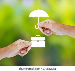 Business Insurance Concept With An Umbrella Covering Business Briefcase