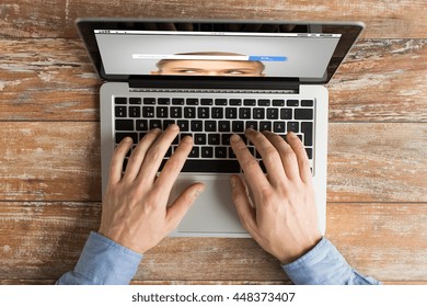 Business, Internet, Information, People And Technology Concept - Close Up Of Male Hands Typing On Laptop With Search Browser Bar On Screen Keyboard On Table