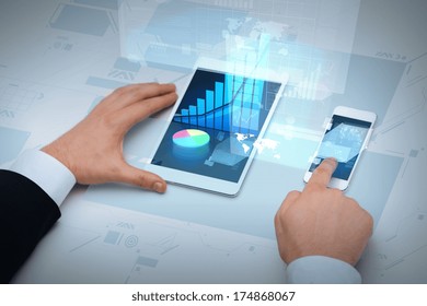 business, internet and technology concept - close up of businessman hands working with table pc and smartphone - Powered by Shutterstock