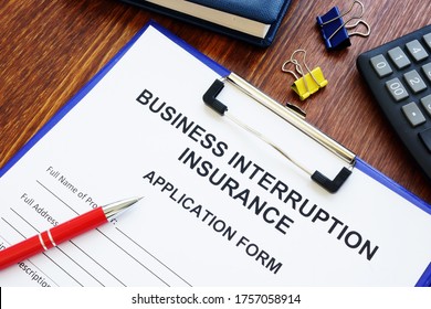 Business Interruption Insurance Form And Red Pen For Signing.