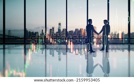 Business investing and brokerage concept with businessmen handshaking in spacious office hall with night city view and virtual glowing raising forex market candlestick