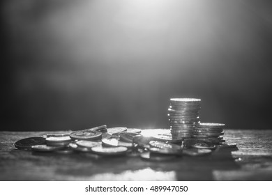 Business investment concept. Pile money coins with sunlight background. Black and white photo - Shutterstock ID 489947050