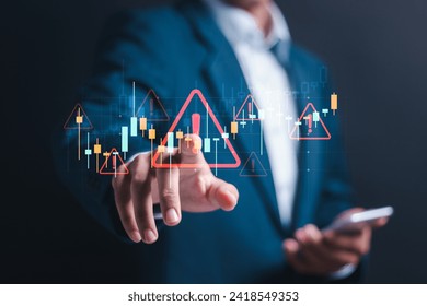 Business investment risks. Businessman use smartphone with virtual stock growth graph with red warning sign for caution in investing economic situation warning, investment in economy crisis.