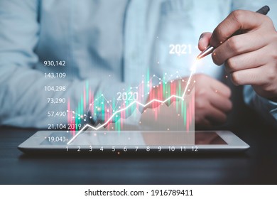 Business investor using mobile tablet to analysis beautiful virtual stock market chart , business analyze by use technology concept.