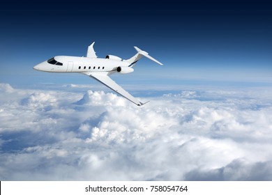 Business jet airplane flying on a high altitude above the clouds