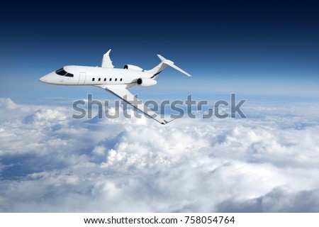 Business jet airplane flying on a high altitude above the clouds Imagine de stoc © 