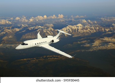 Business Jet Airplane Flying Over Mountains.