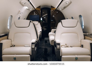 Business jet airplane interior with comfortable leather seats
