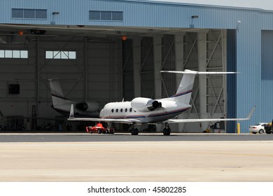 Business Jet Airplanes Parked Near Airport Hangar