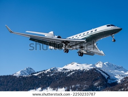 Business jet during landing at Engadin airport during the winter holidays in Switzerland. The way to travel as a successful business owner