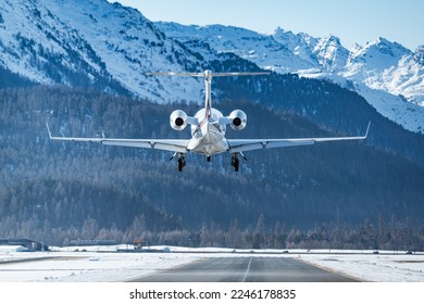 Business jet landing at the alpine airport in Samedan in the engadin valley in the Swiss alps. The luxurious way to travel to the world famous winter ski resort. The way rich people travel.  - Powered by Shutterstock